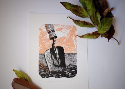 lino print of a trowel in a bed of soil.