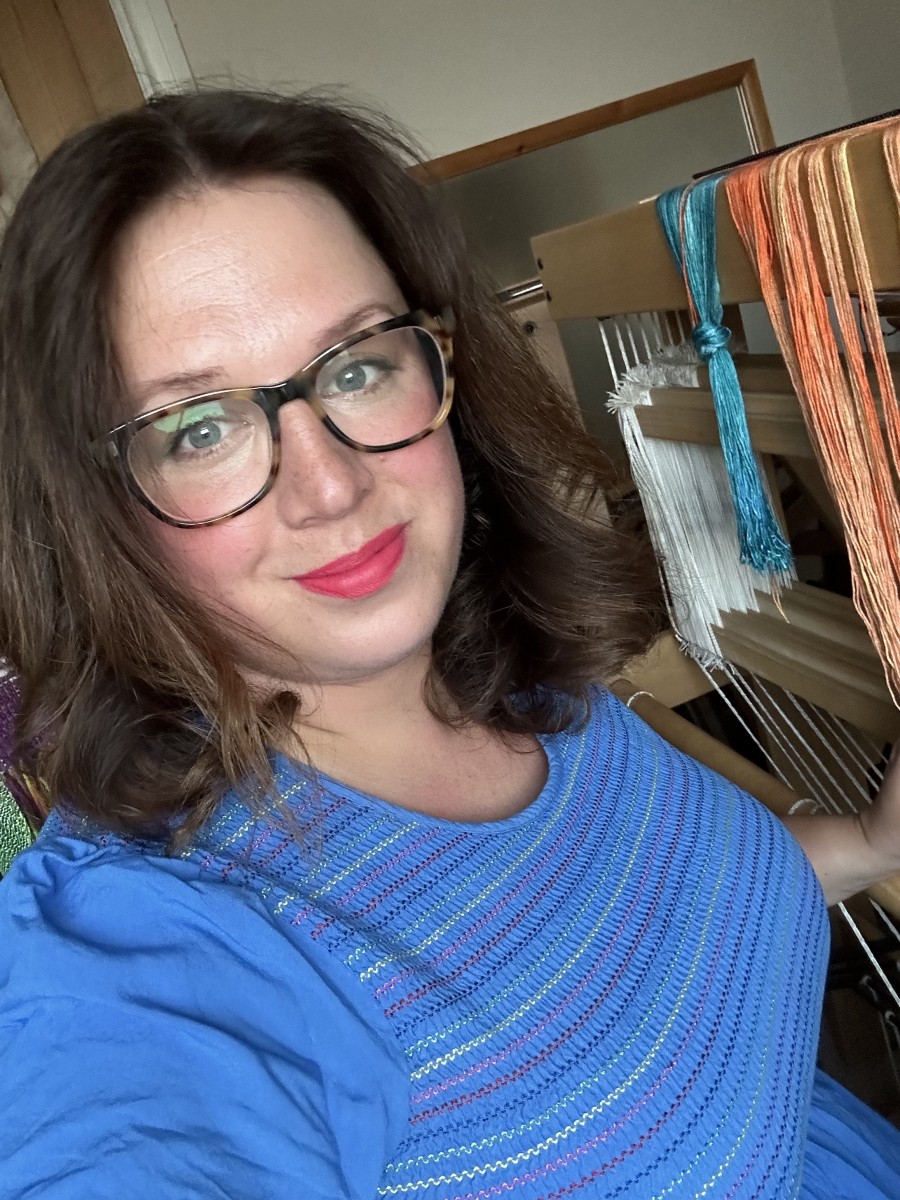 Artist's photo Emily Murch sitting at a loom