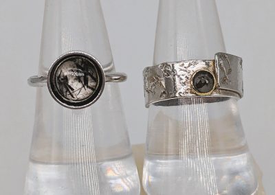 Amanda-Gragam-tourmalinated-quartz-ring-and-grey-diamond-ring-set-in-18-ct-gold.-Ring-band-textured-on-Derbyysgire-limestone-block